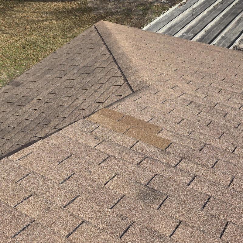 Asphalt shingle roof with hail damage and replacement shingles