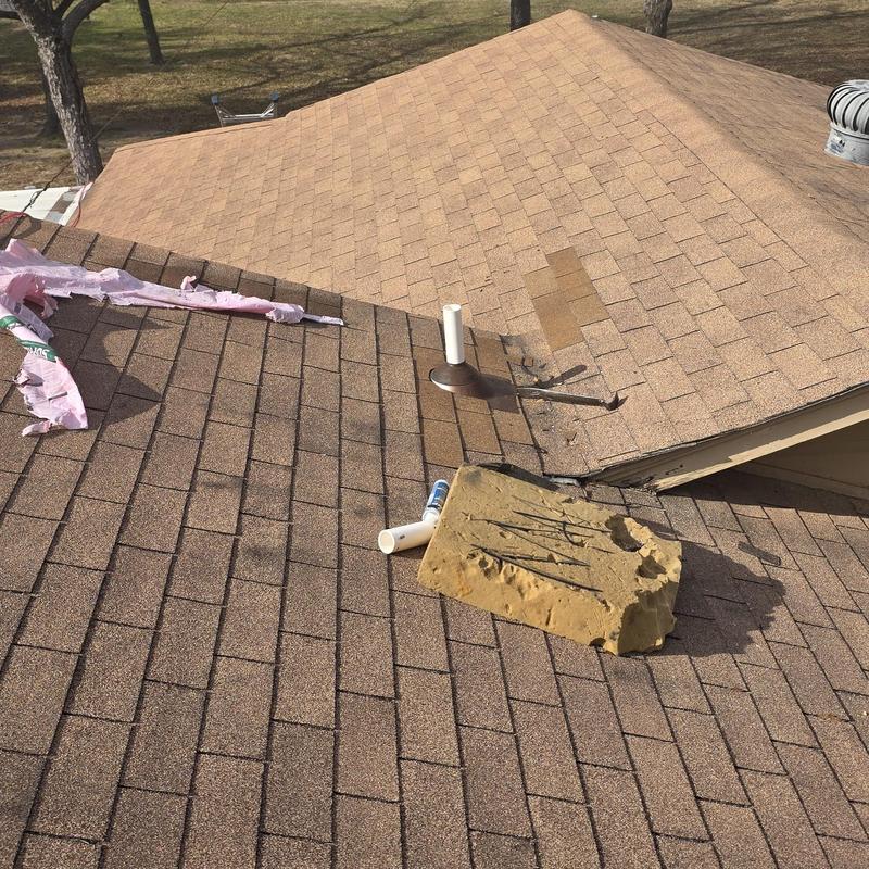 Asphalt shingle roof with hail damage and debris
