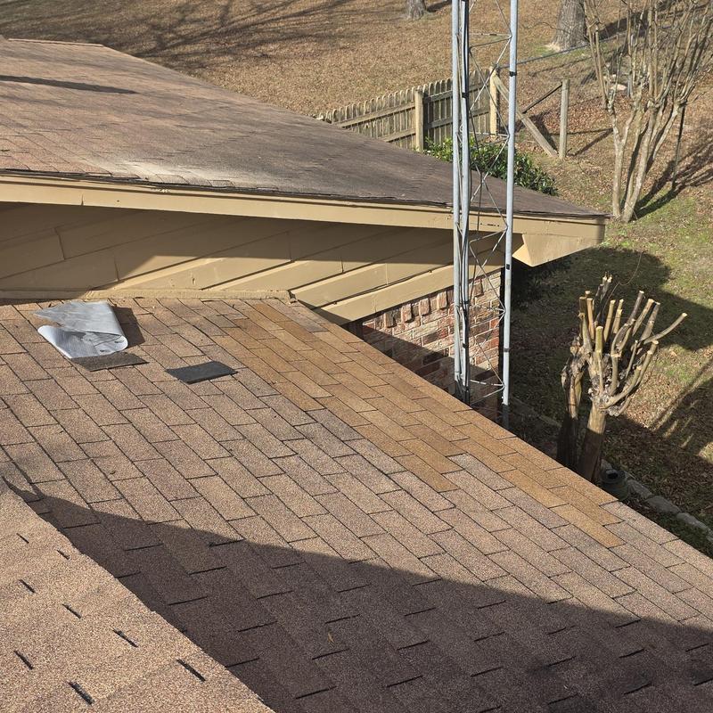 Asphalt shingle roof with hail damage and patch repairs