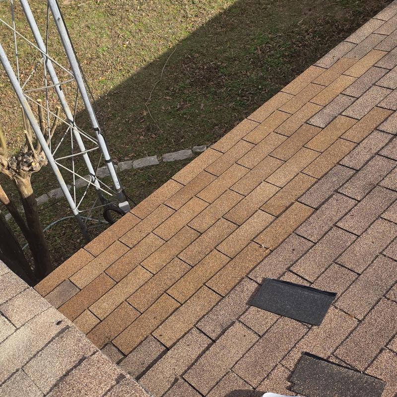 Asphalt shingle roof with hail damage and repairs