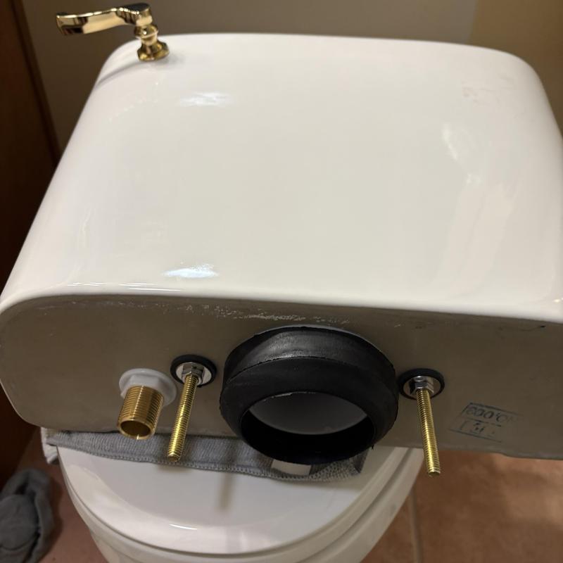 Toilet tank with mounting bolts and gasket component