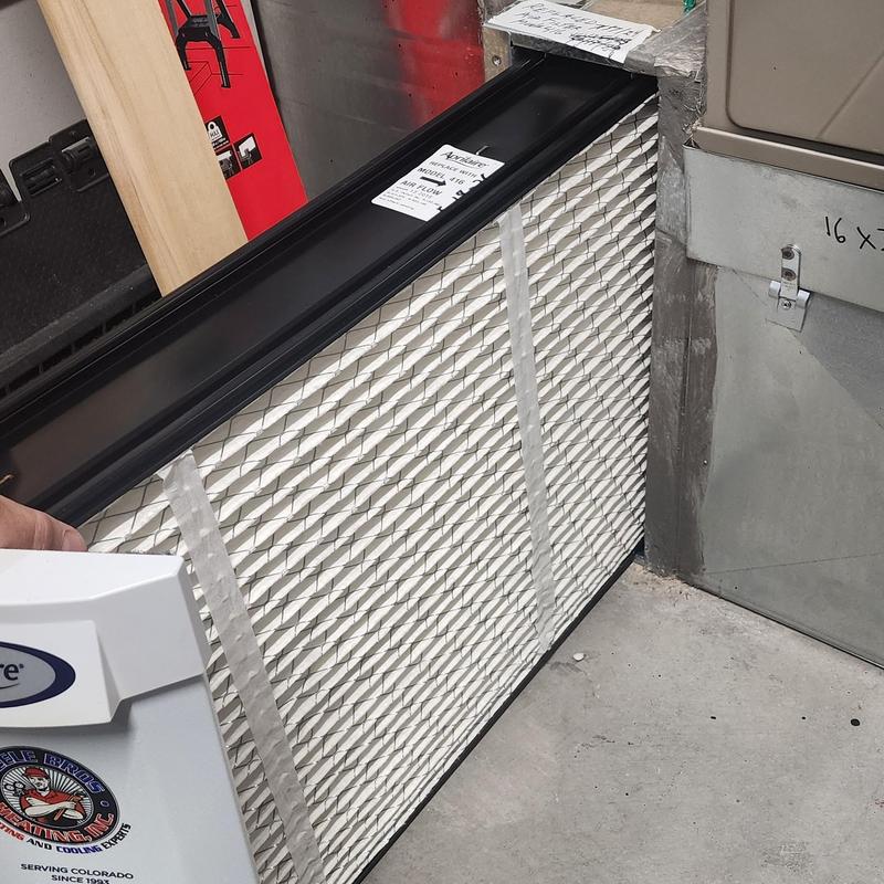 Aprilaire air cleaner filter being replaced