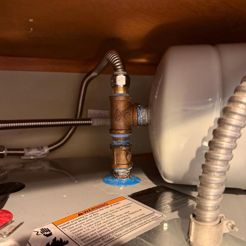 Brass nipple on water heater with flexible connectors