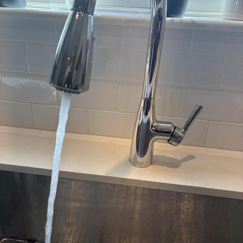 Kitchen faucet with flowing hot water during repair