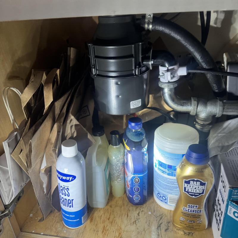 Garbage disposal under-sink installation with cleaning supplies