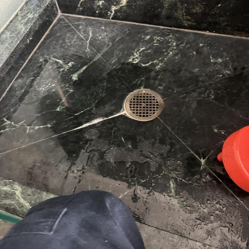 Shower drain with hair clog removal in marble floor