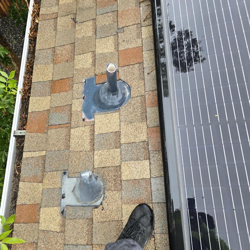 Pipe jacks on shingle roof near solar panel installation Pipe jacks on shingle roof near solar panel installation