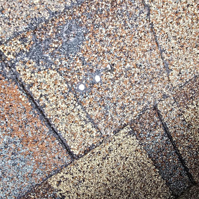 Asphalt shingle roof with worn sealant spots Asphalt shingle roof with worn sealant spots