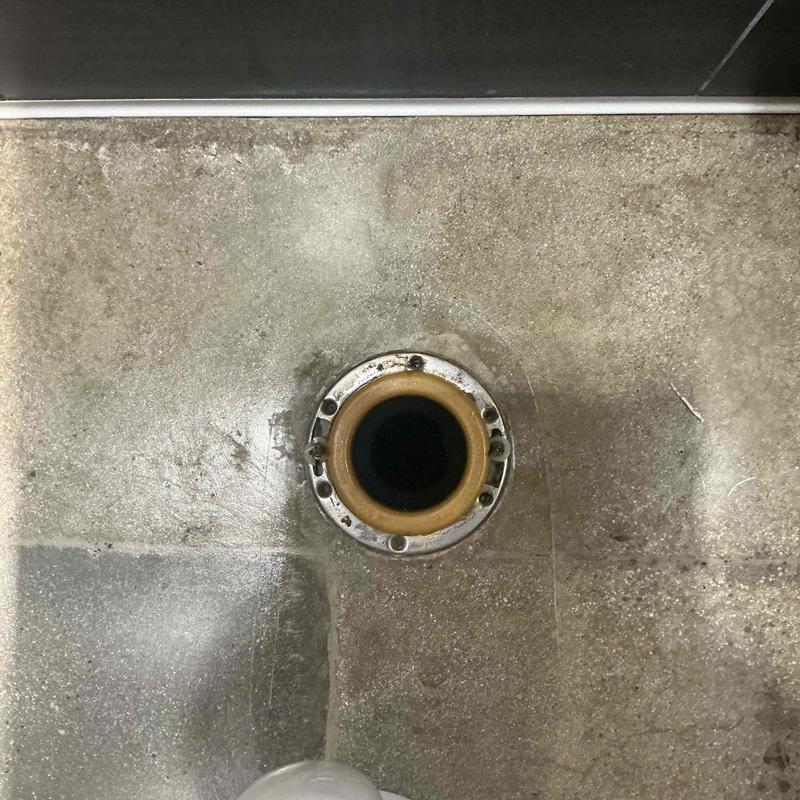 Commercial toilet flange with old wax ring residue