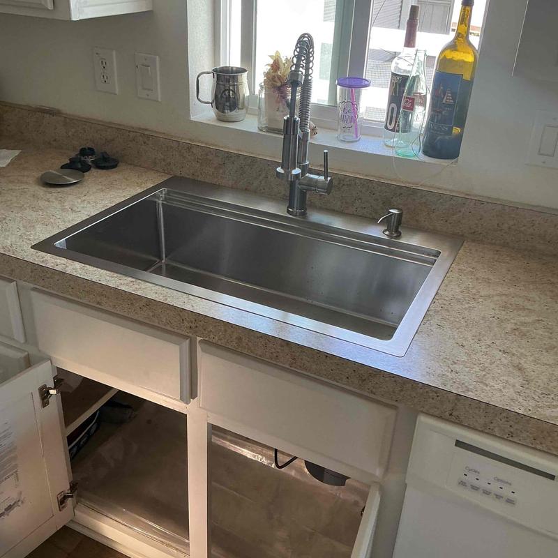 Kitchen sink installation with modern faucet on countertop