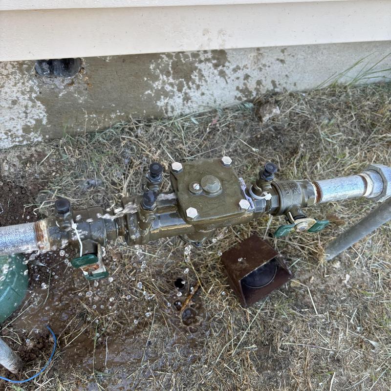 Irrigation valve and backflow leaking water on ground