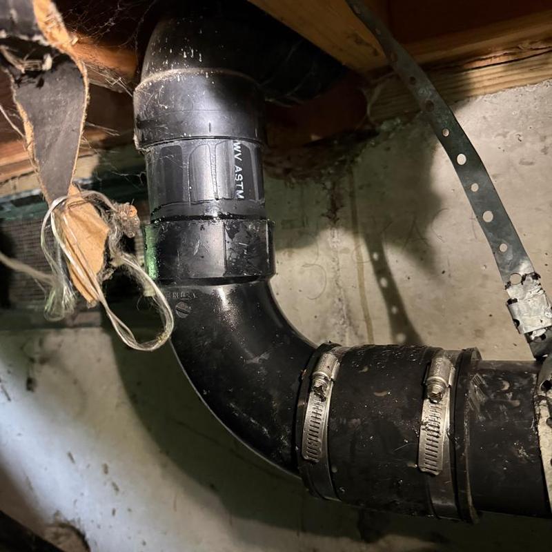 3" ABS drain pipe with clamps and fittings under floor