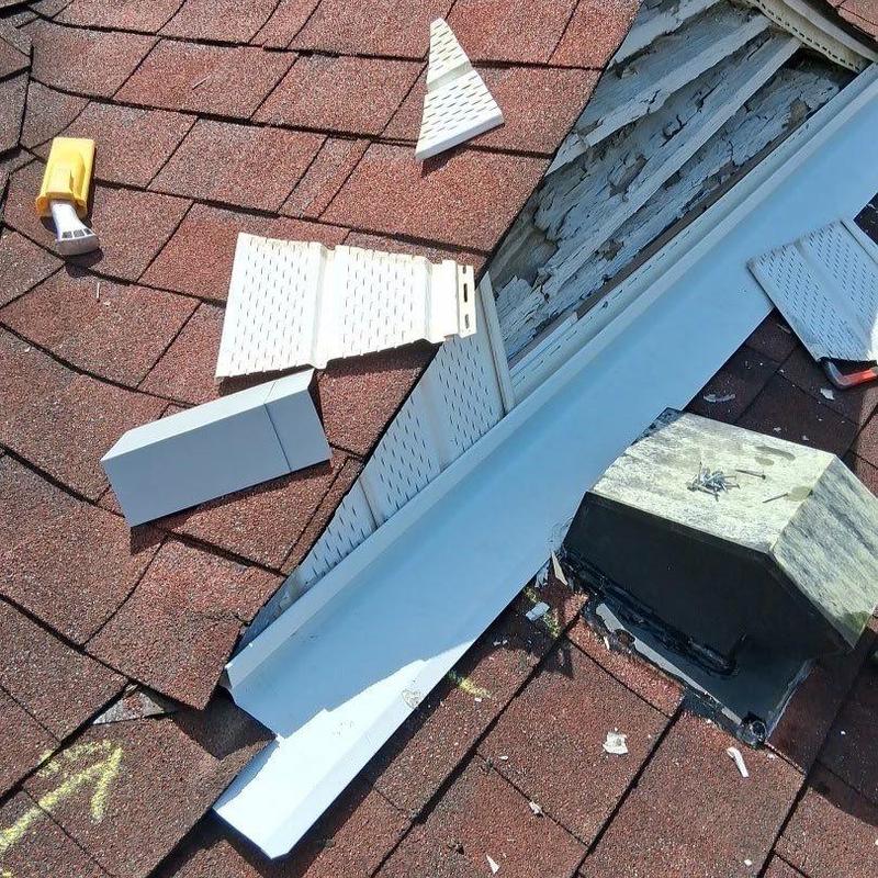 Roof flashing with damaged siding and debris on shingles