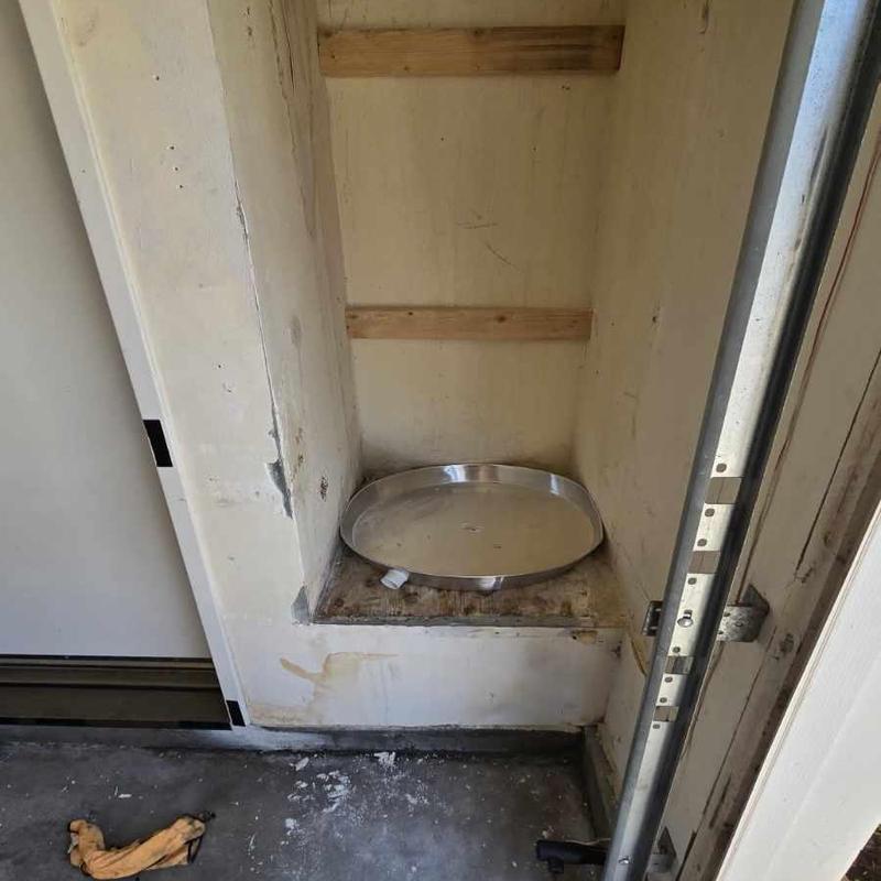 Water heater drain pan installation in utility closet