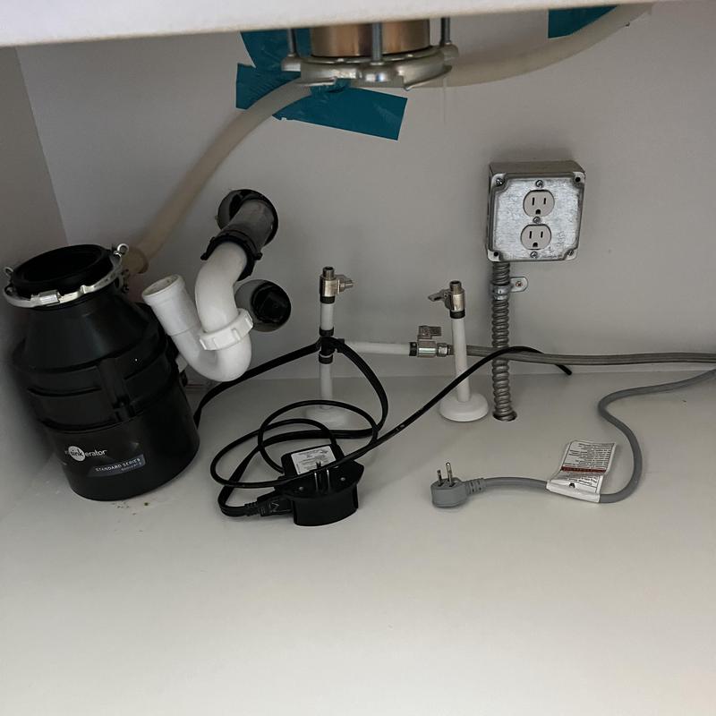 Garbage disposal and drain connections under sink