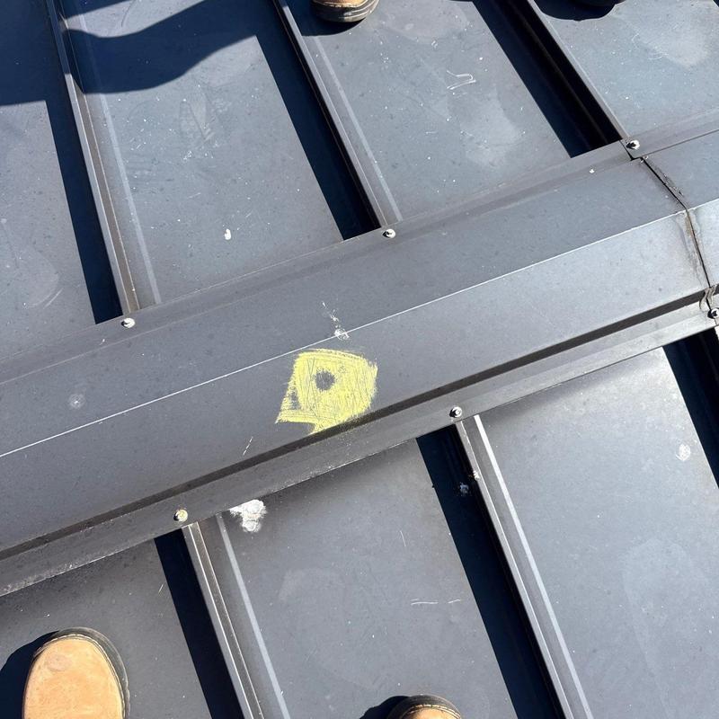 Standing seam metal roof with chalk hail damage mark