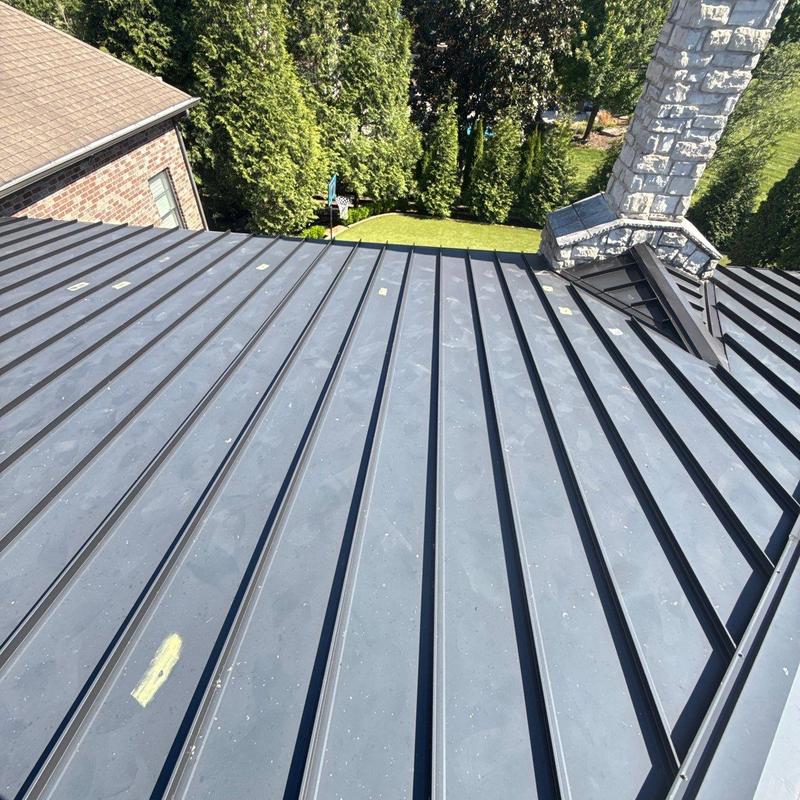 Standing seam metal roof with hail damage marks