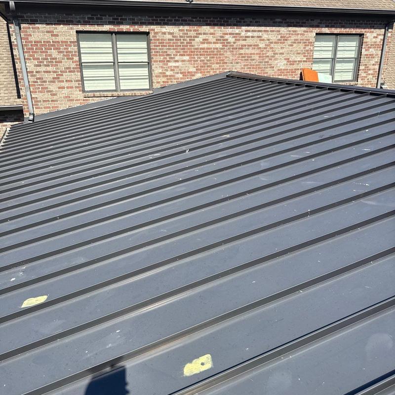 Standing seam metal roof with hail damage marks
