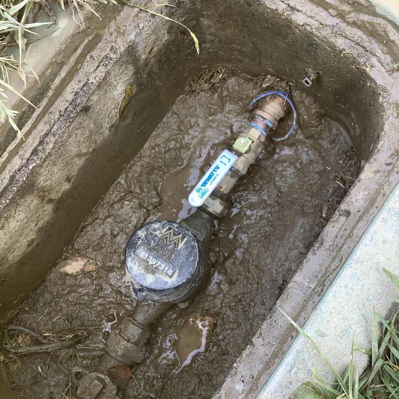 Water meter shut-off valve installation in mud-filled box