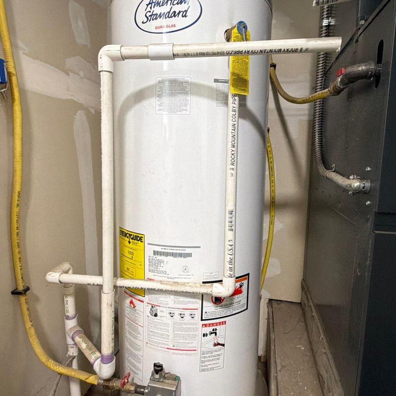 Water heater PVC vent piping installation in utility room Water heater PVC vent piping installation in utility room