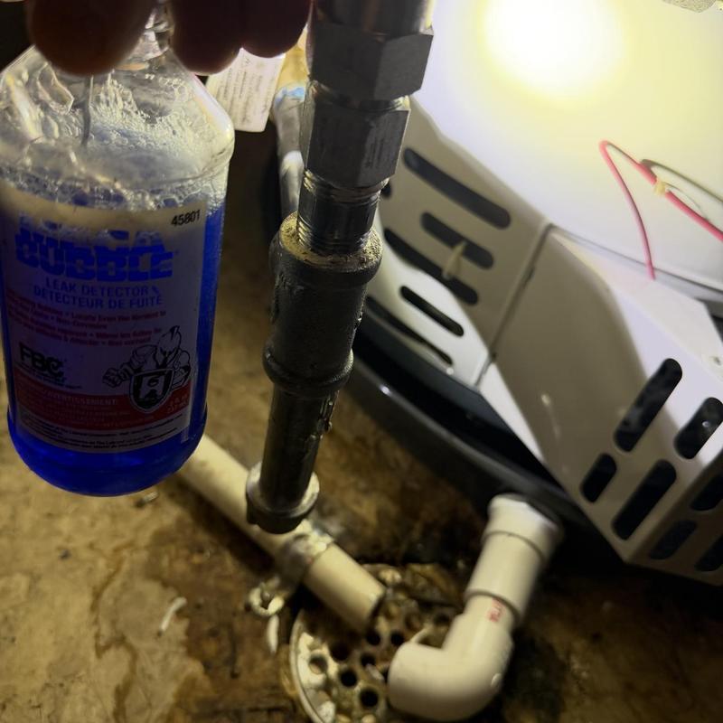 Gas pipe with leak detector liquid in basement area Gas pipe with leak detector liquid in basement area