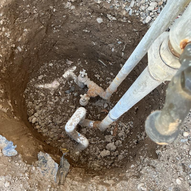 Sprinkler shutoff assembly and piping in ground hole