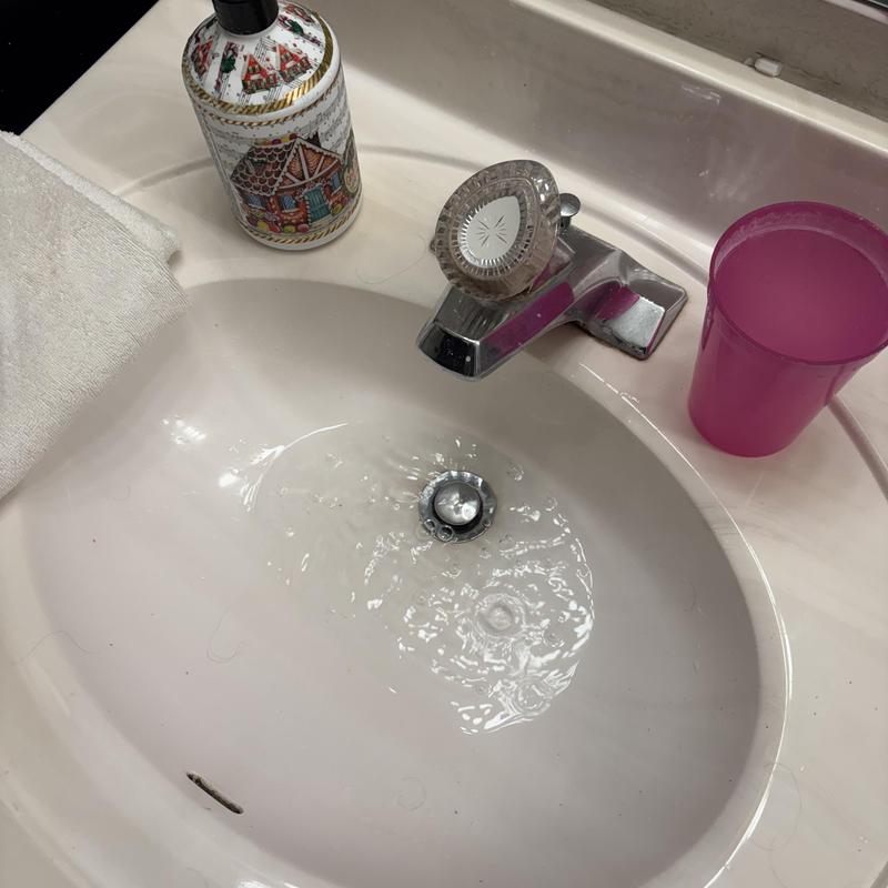 Bathroom sink drain with running water and faucet