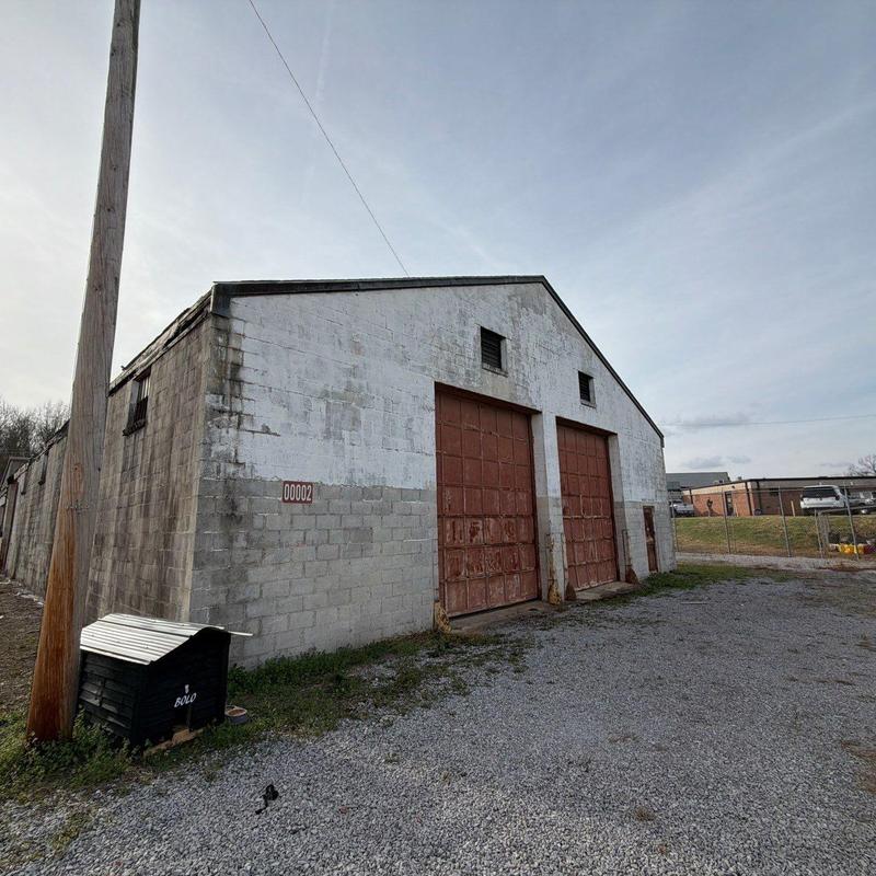 Metal garage doors with rust and weathering at facility