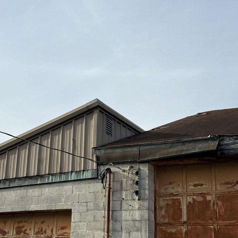 Roof gutter system with hail damage on facility building