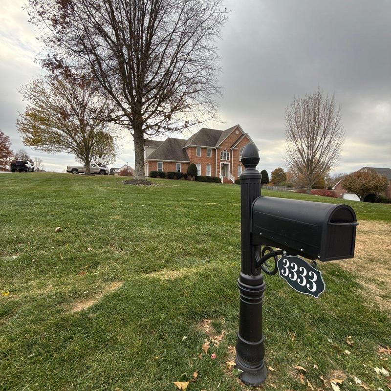 Black mailbox with house number 3333 in lawn