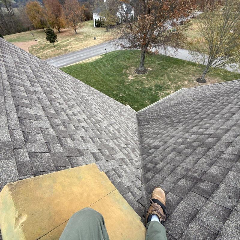 Asphalt shingle roof with ridge vent and flashing inspection