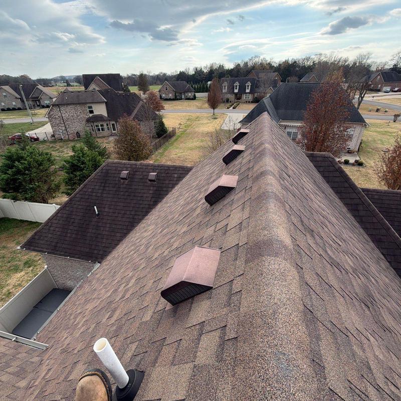 Asphalt shingle roof with ventilation caps and flashing