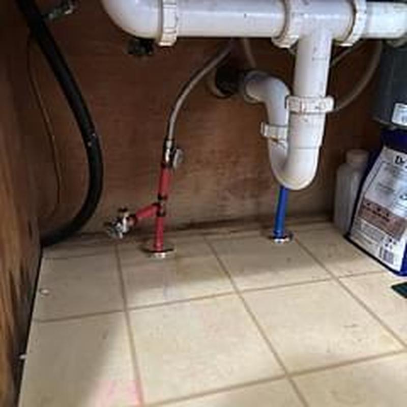 Hot and cold water lines with shutoff valves under sink