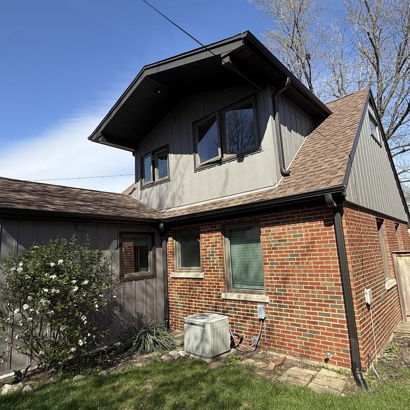 Composite siding with gutters and soffit on house exterior Composite siding with gutters and soffit on house exterior