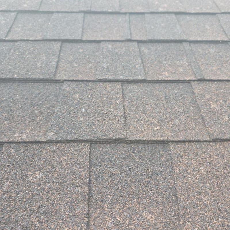 Asphalt roof shingles close-up inspection in Houston, TX