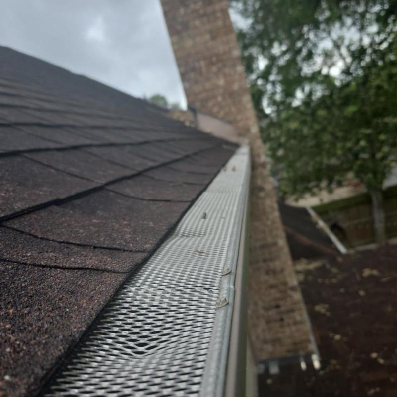 Asphalt shingle roof and metal gutter guard installation