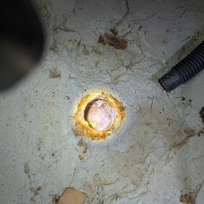 Copper drain pipe end with corrosion and debris buildup Copper drain pipe end with corrosion and debris buildup