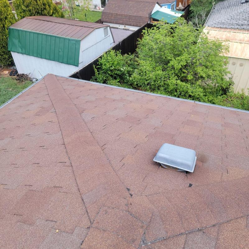 T-lock shingle roof with ventilation cap and aging signs T-lock shingle roof with ventilation cap and aging signs