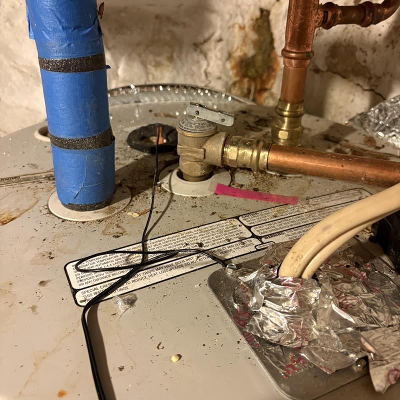 Electric water heater with pressure relief valve and piping