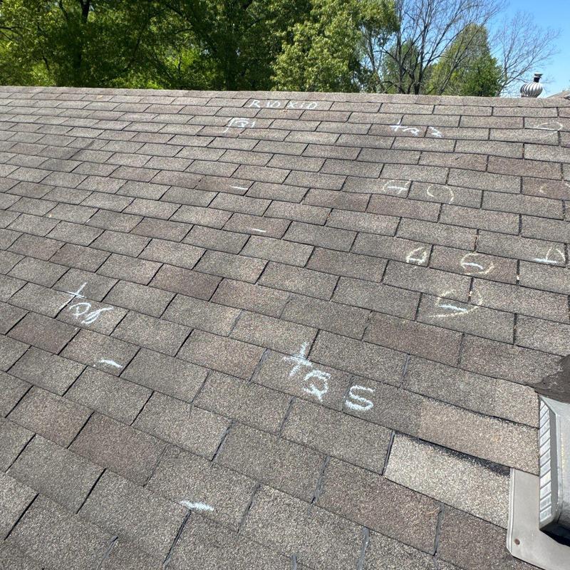 Asphalt shingle roof hail damage marked for repair Asphalt shingle roof hail damage marked for repair