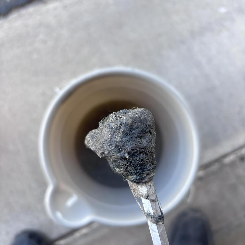 Drain line clog removed from cleanout access pipe