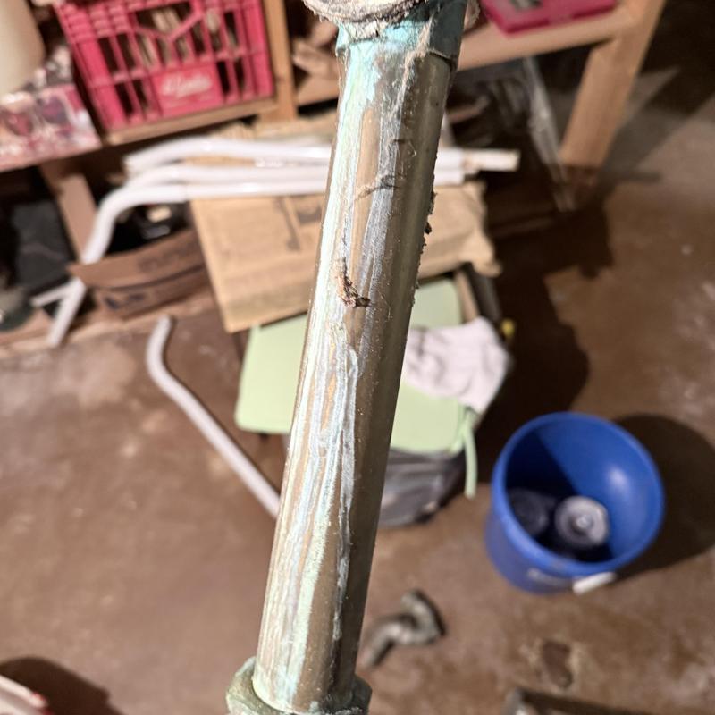 Drain pipe with corrosion and buildup in basement area