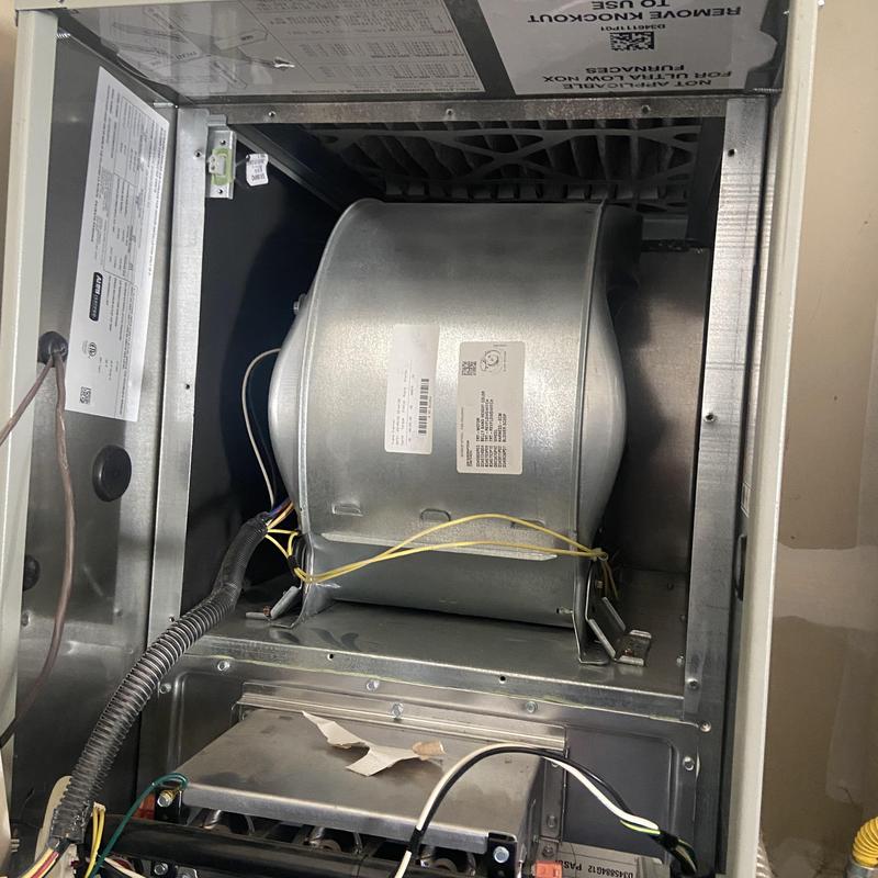 Furnace blower motor inside HVAC unit with wiring