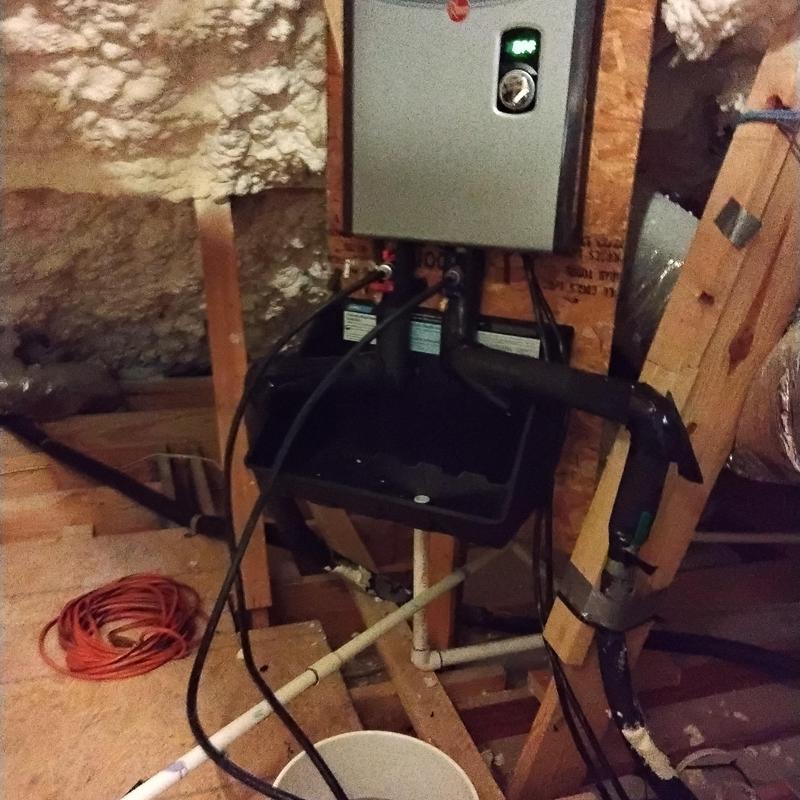 Tankless water heater flushing setup in attic