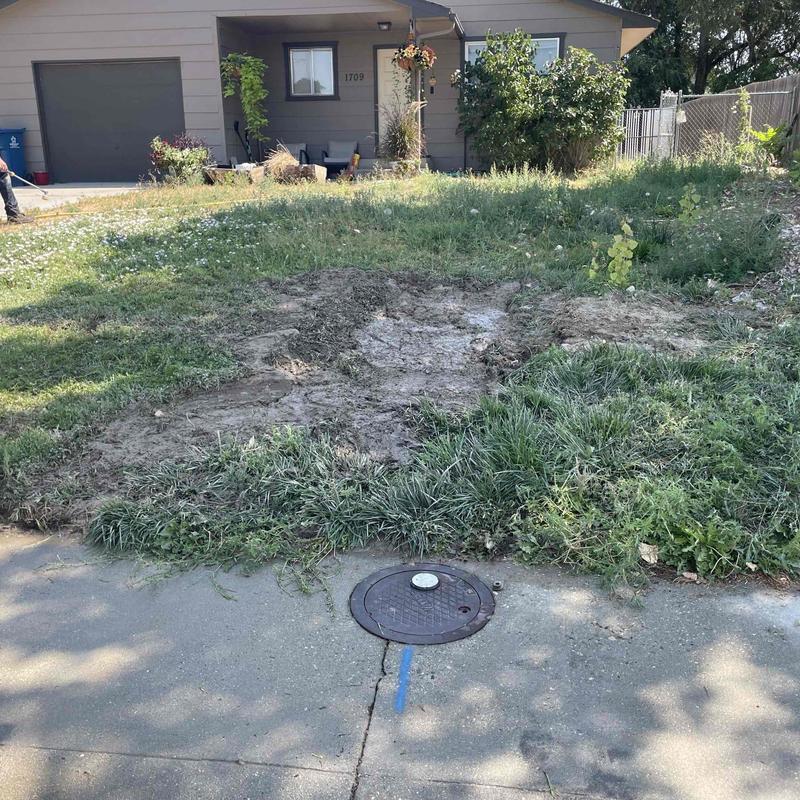 Copper water main excavation site in residential yard Copper water main excavation site in residential yard