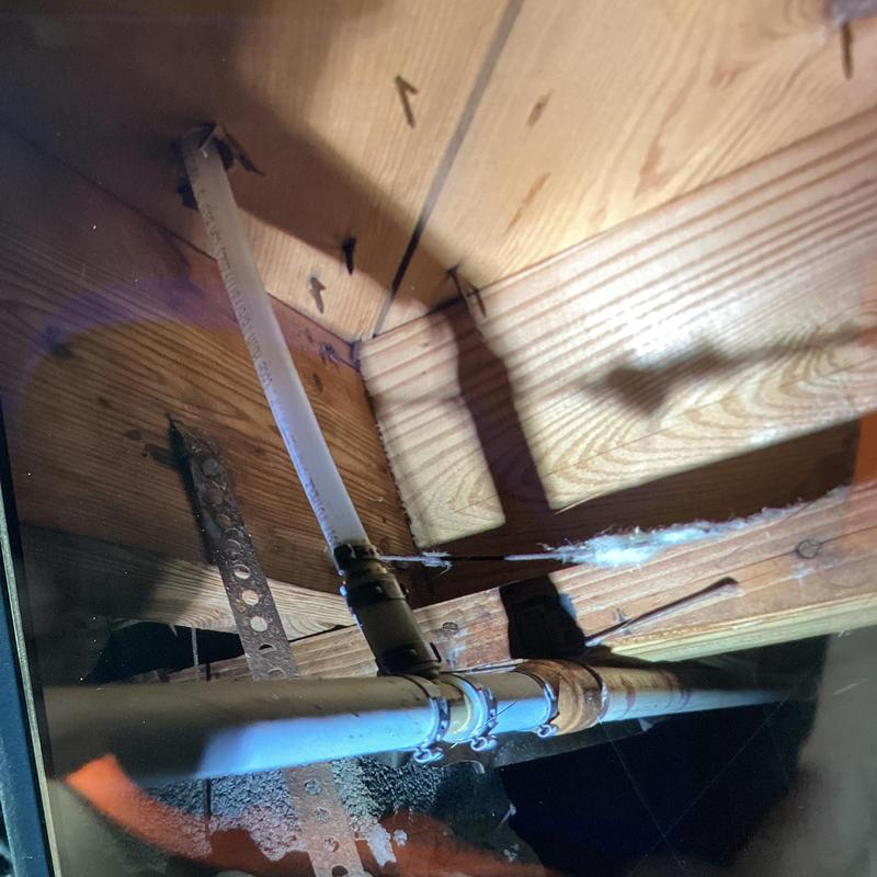 Pex water line with PVC trunk and fittings in crawl space