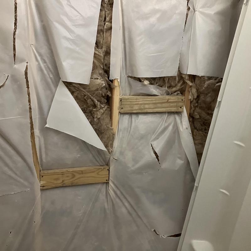 Shower pan and wall surround demolition with insulation exposed