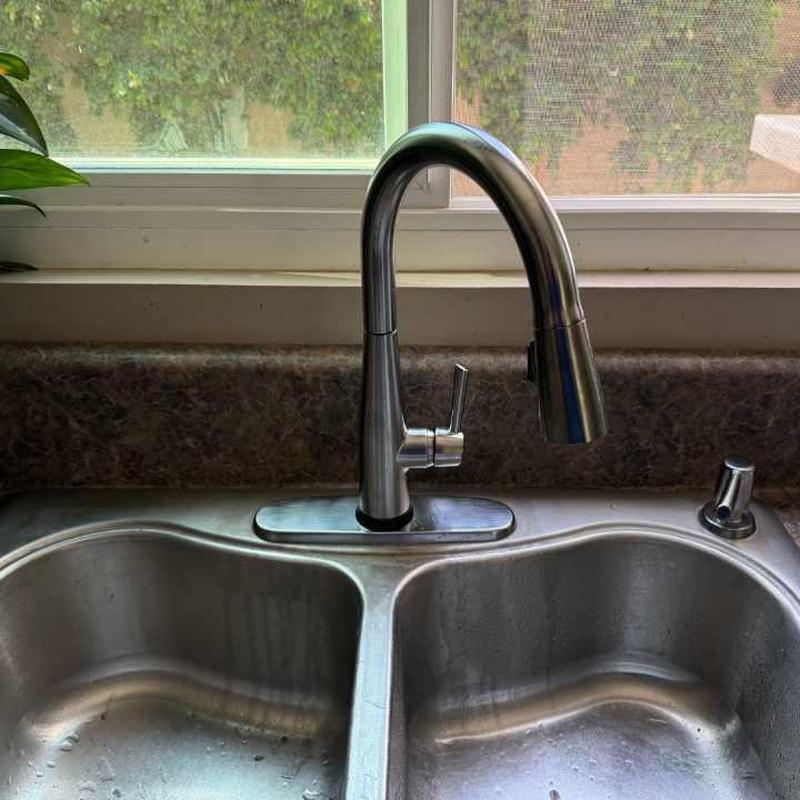 Kitchen faucet and double sink with window background