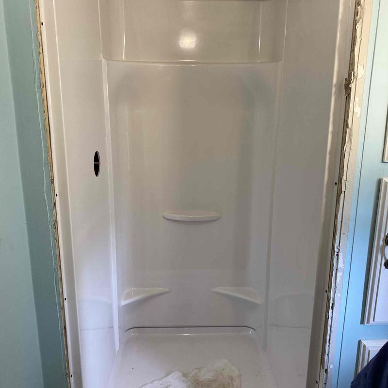 Shower enclosure installation in home bathroom
