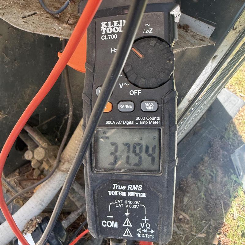 Digital clamp meter measuring HVAC system voltage Digital clamp meter measuring HVAC system voltage